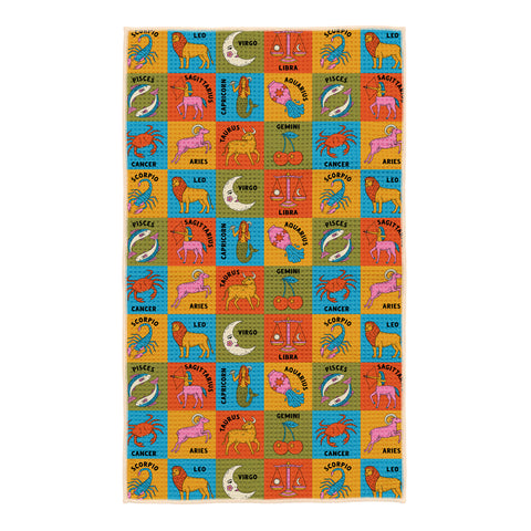 Colorful zodiac kitchen tea towel with repeating pattern of all 12 astrology signs including scorpio, leo, virgo, libra, pisces, sagittarius, cancer, aries, taurus, gemini, and aquarius on bright blue, yellow, orange and green squares
