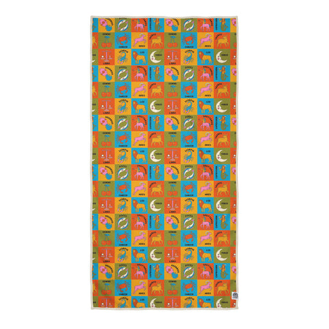Zodiac travel towel with bright multi-colored grid pattern featuring all 12 astrology signs, animals, and celestial symbols in vibrant orange, blue, yellow, and green