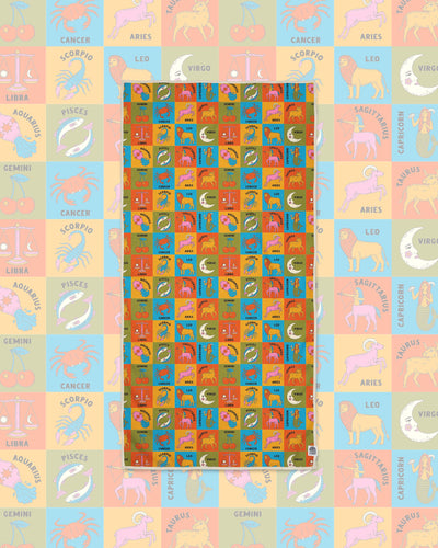 Zodiac Wander & Travel Towel with a grid of colorful animal and sign illustrations on a faded matching background