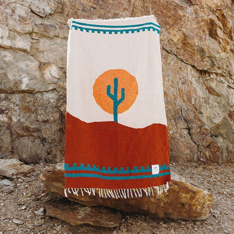 Cozy, versatile Arizona Blanket: handwoven from recycled clothing, featuring a cactus design in a beautiful desert sunset palette by Trek Light.