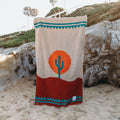 Handwoven Arizona blanket by Trek Light with cactus design and sunset colors, made from recycled clothing materials. Beautiful, cozy, versatile.