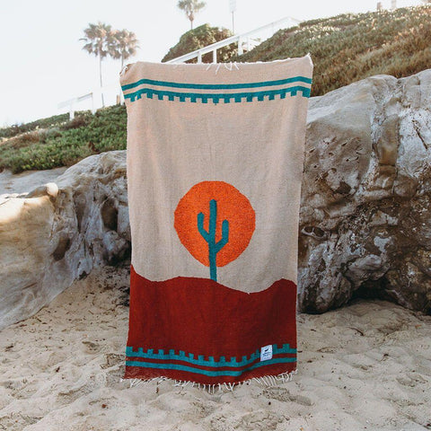 Handwoven Arizona blanket by Trek Light with cactus design and sunset colors, made from recycled clothing materials. Beautiful, cozy, versatile.