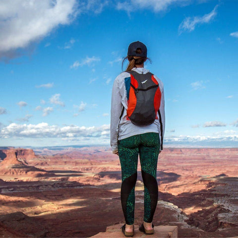 Traveler enjoying stunning canyon view with Bindle Daypack, the ultralight, ultra-strong backpack perfect for Trek Light adventures.