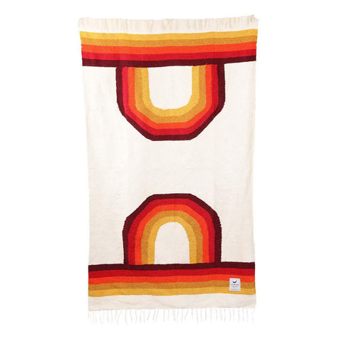 Trek Light Bowie Blanket with rainbow design, handmade from recycled materials, offering a vintage vibe and sustainable warmth.