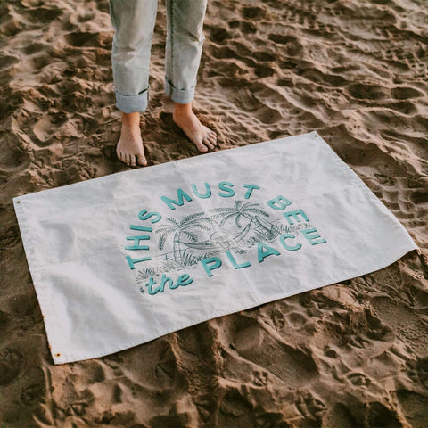 Large This Must Be The Place Trek Light canvas flag on sandy beach, featuring hand-screened print on natural cotton with brass grommets.