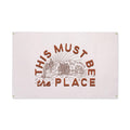 "This Must Be The Place" canvas flag wall art by Trek Light, featuring 10oz natural canvas and hand-screened desert design.