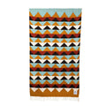 Handwoven Cascade Blanket with colorful geometric pattern, made from recycled clothing materials, cozy and eco-friendly. By Trek Light.