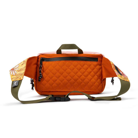 Orange Trek Light bag with floral strap design, perfect for hiking and outdoor adventures.