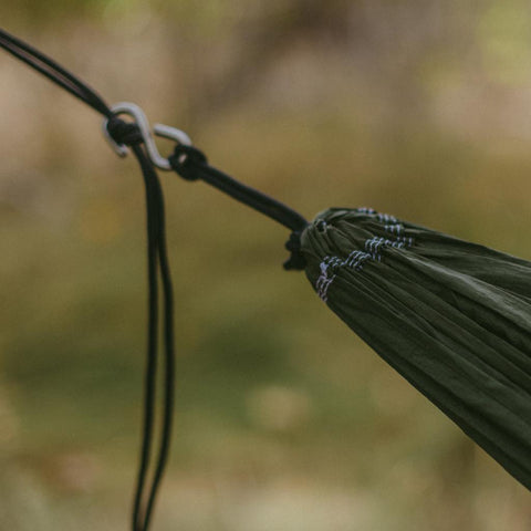 Trek Light Go Anywhere Rope Kit securing a hammock, showing the lightweight, knotted nylon cord ready for travel adventure setup.