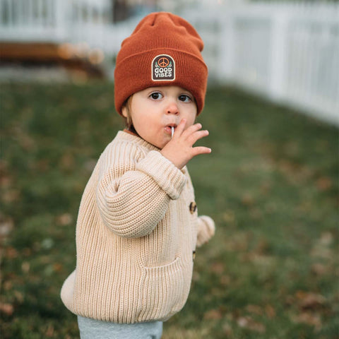 Adorable toddler in a Trek Light Good Vibes Kids Beanie, bringing warmth and cuteness with playful charm.