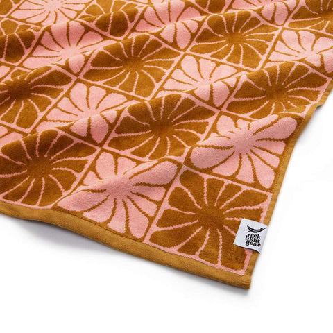 Groovy Flowers Bath Towel by Trek Light, featuring eco-friendly cotton with a soft and absorbent design and vibrant floral pattern.