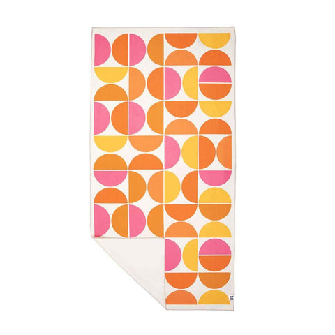 Half Moon Wander Towel with vibrant pink, orange, and yellow geometric design. Trek Light line; eco-friendly, portable, quick-dry towel.