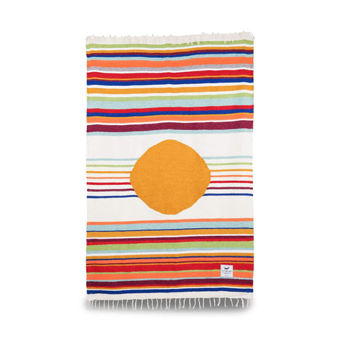 Colorful handwoven blanket with orange circle, part of Trek Light's eco-friendly Blanket + Leather Carrier Bundle.