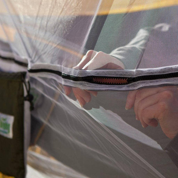 Hands zipping the Bug Free Hammock Shield by Trek Light, keeping bugs out for uninterrupted relaxation. Perfect hammock accessory.