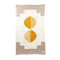 Trek Light handwoven blanket in geometric design with yellow accents, made from recycled materials. Includes eco-friendly leather carrier.