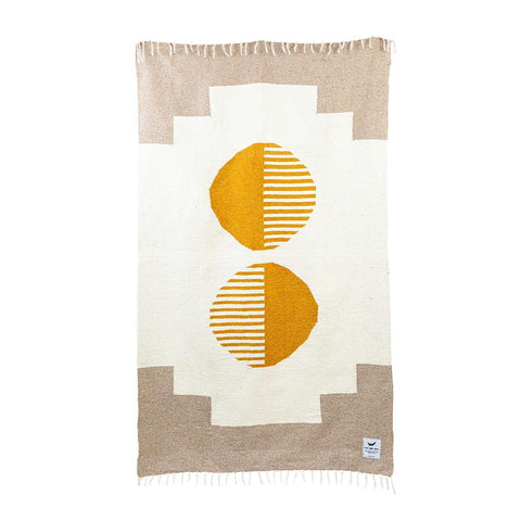 Trek Light handwoven blanket in geometric design with yellow accents, made from recycled materials. Includes eco-friendly leather carrier.