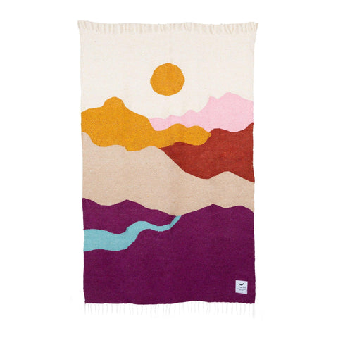 Handwoven Mountain Sunrise Blanket made from recycled clothing. Beautiful, cozy, and versatile textile art piece in vibrant colors. By Trek Light.