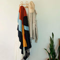 Cozy handwoven Mountains Blanket by Trek Light hanging stylishly in a home, ready to bring warmth and art to your space.