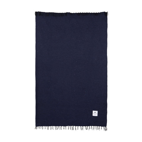 Handwoven blanket in dark blue made from 100% recycled materials, part of the Trek Light Blanket + Leather Carrier Bundle.