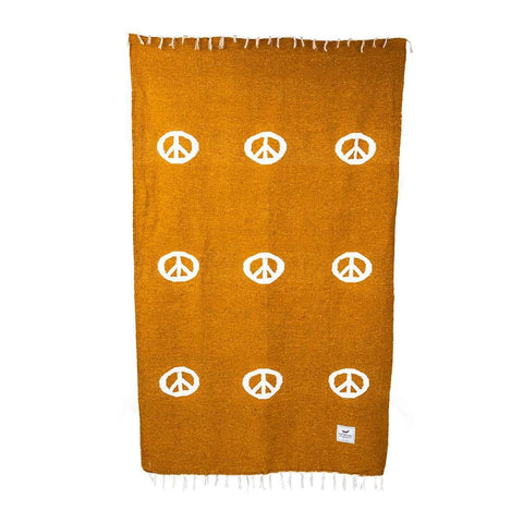 Cozy handwoven Peace Blanket by Trek Light, made from beautiful recycled clothing materials, featuring peace symbols, versatile for any decor.