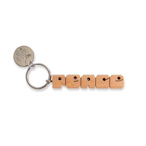 Trek Light PEACE wood keychain with nickel ring, hand-cut design, perfect for an affordable and thoughtful gift.