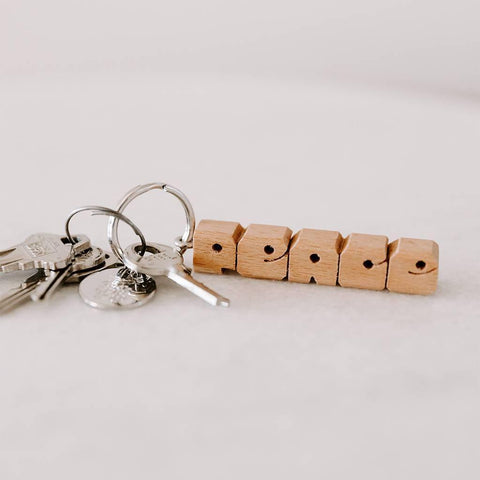 Trek Light PEACE wood keychain with nickel split-ring hardware. Hand-cut design, perfect gift or stylish accessory for keys. 2.5 inch size.