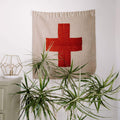 Positive Vibrations Blankestry with red cross design, handwoven art from Trek Light, perfect wall decor with eco-friendly materials.