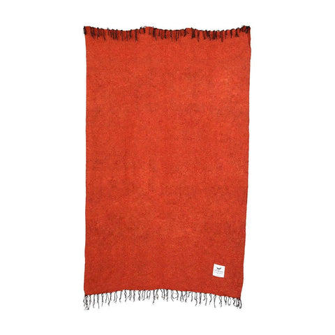 Red Rocks Blanket by Trek Light, cozy handwoven throw made from recycled clothing materials, versatile and beautiful, in vibrant red.