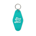 Stay Wild Key Tag by Trek Light: Retro vintage-style keychain in teal with bold white lettering. Perfect for your adventurous lifestyle.