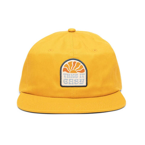 Yellow "Take It Easy" snapback hat with flat brim, featuring Trek Light logo. Unisex 100% cotton twill, perfect for casual adventures.