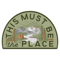 This Must Be The Place Mountain Sticker with A-Frame Cabin, Trek Light, and nature scene, weatherproof vinyl.