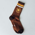 You Are My Sunshine socks by Trek Light - cozy brown crew socks with yellow sun design, perfect for comfort and style.